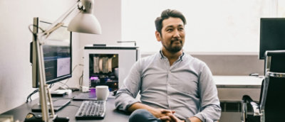 A person sitting at a desk using a computer.