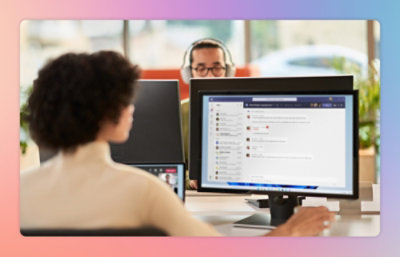 A person at a desk on a computer in an office