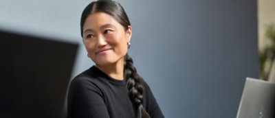 A person with a braided hair smiling