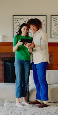 Two women watcing something on tab.