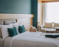 A photo of a tidied bed in a hotel.