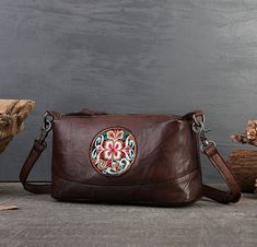 Luxurious Material: Soft, supple genuine leather that develops a rich patina over time. ​Vintage Ethnic Design: Intricate embroidery inspired by traditional motifs, paired with a cozy pillow-shaped silhouette. ​Multi-Functional: Adjustable crossbody strap, multiple interior pockets, and a roomy main compartment for laptops, purses, or travel essentials. ​Chic Versatility: Transitions effortlessly from daytime errands to evening gatherings or weekend getaways. ​Bohemian Flair: Handcrafted details and earthy tones for a free-spirited, statement-making look. Ideal for minimalist, maximalist, or retro-inspired wardrobes, this bag pairs effortlessly with jeans and boots or flowy dresses. Whether you’re heading to work, a café, or a weekend hike, it’s your go-to companion for style and function. Traditional Soft Leather Bag, Artisan Soft Leather Bag For Gift, Traditional Leather Bags With Removable Pouch, Traditional Brown Soft Leather Bag, Traditional Leather Crossbody Shoulder Bag, Vintage Brown Leather Bag For Gift, Traditional Soft Leather Satchel Bag, Vintage Hand-tooled Shoulder Bag Gift, Traditional Brown Crossbody Shoulder Bag