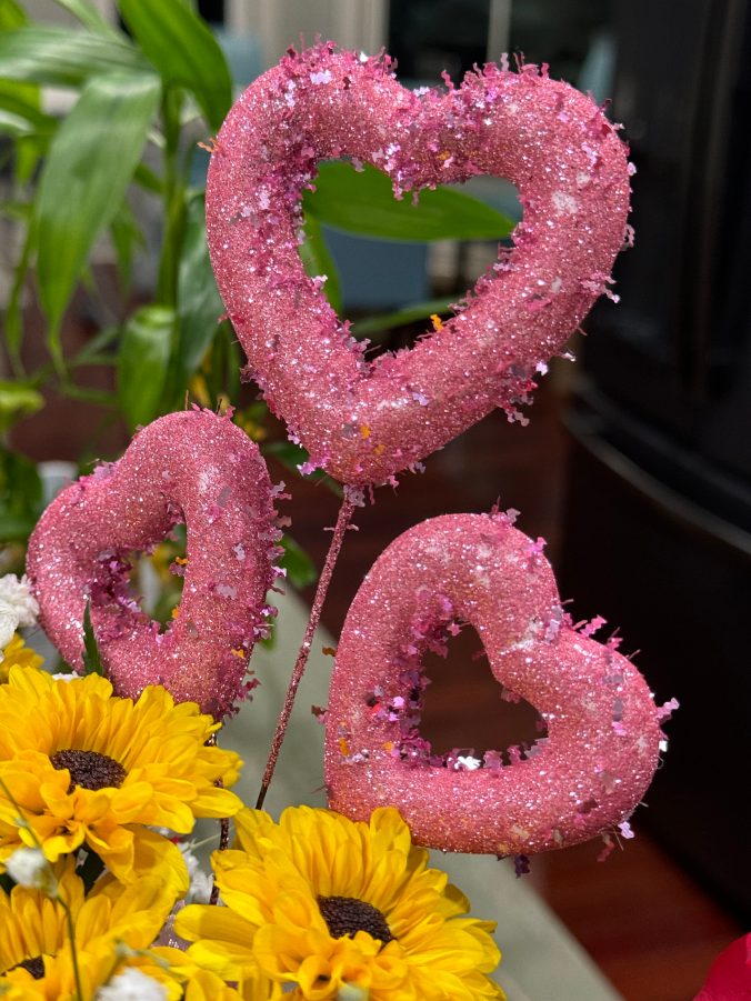 a trio of sparkly pink hearts embellishing the beautiful arrangement of flowers my daughter Alison sent on the occasion of my first anniversary of what she calls my Second Chance Day