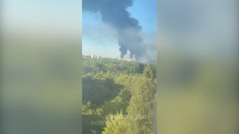 Smoke billows out in the distance 