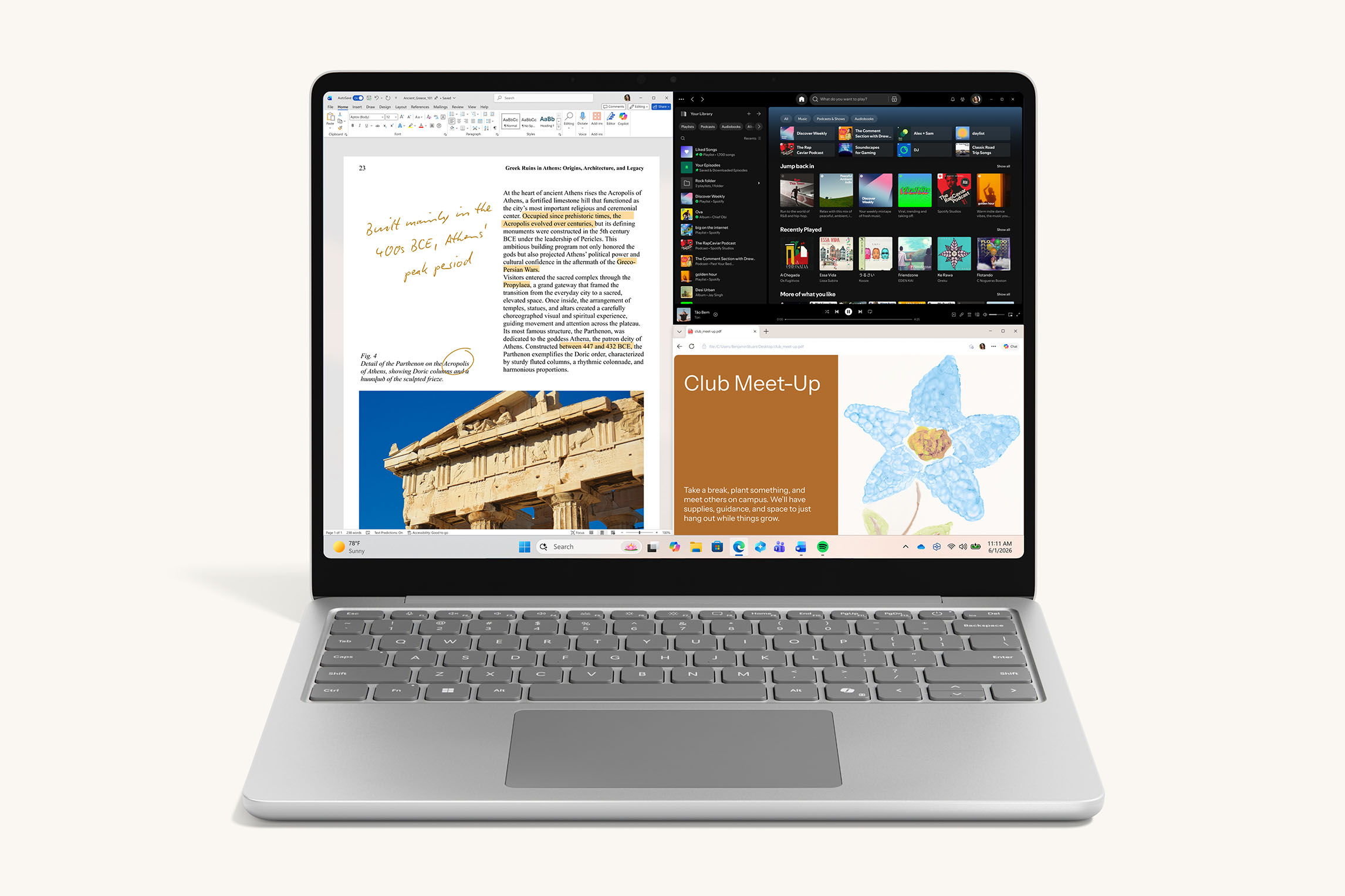 Platinum 13-inch laptop displaying a split-screen view with document editing, music app, and web content
