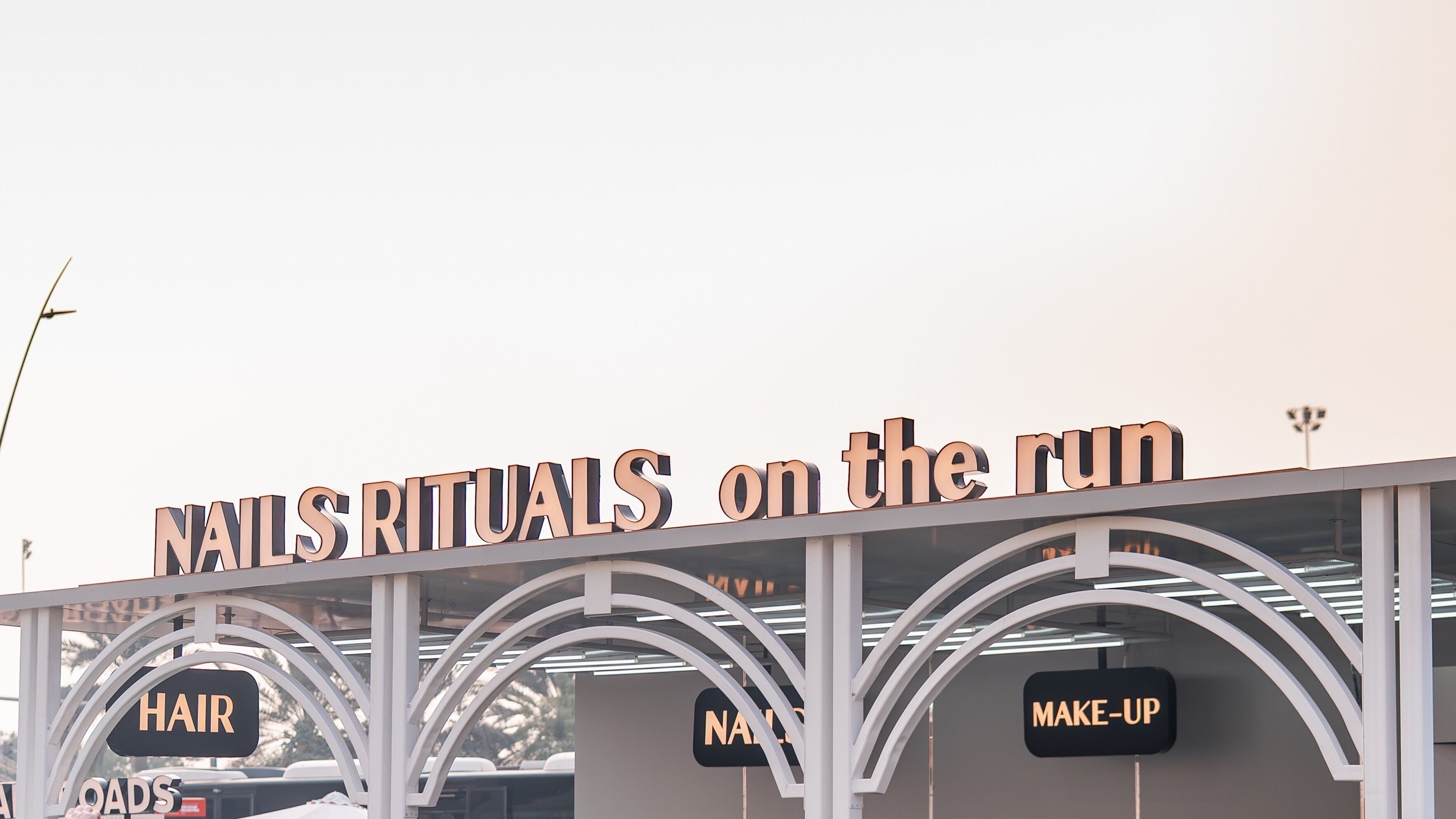 Exterior of Nails Rituals Kiosk For Him & Her in أبو ظبي, أبو ظبي, AE with signage for hair and makeup services.