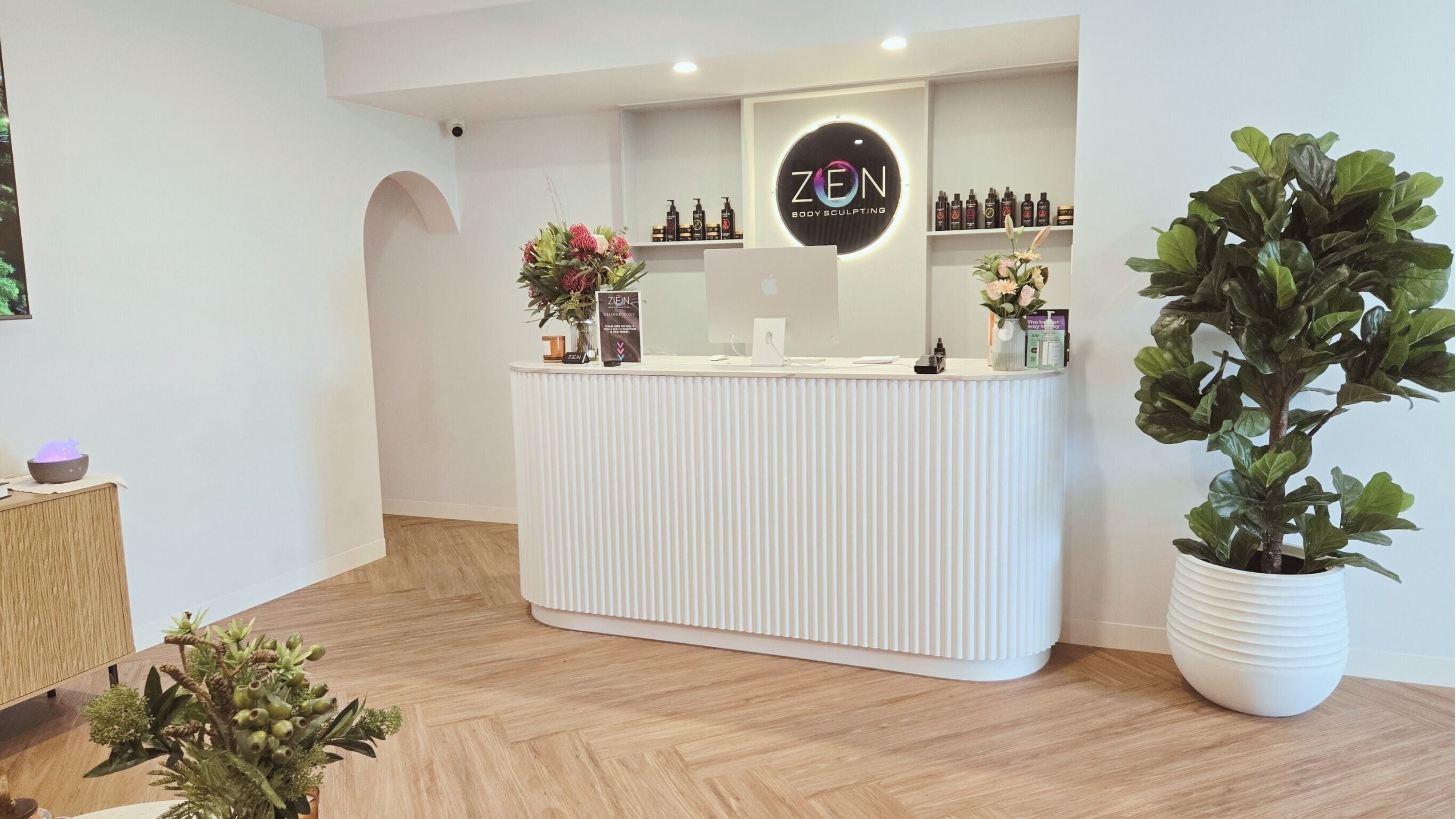 Elegant Zen Body Sculpting lobby in Melbourne, Victoria, AU with chic decor and warm lighting.