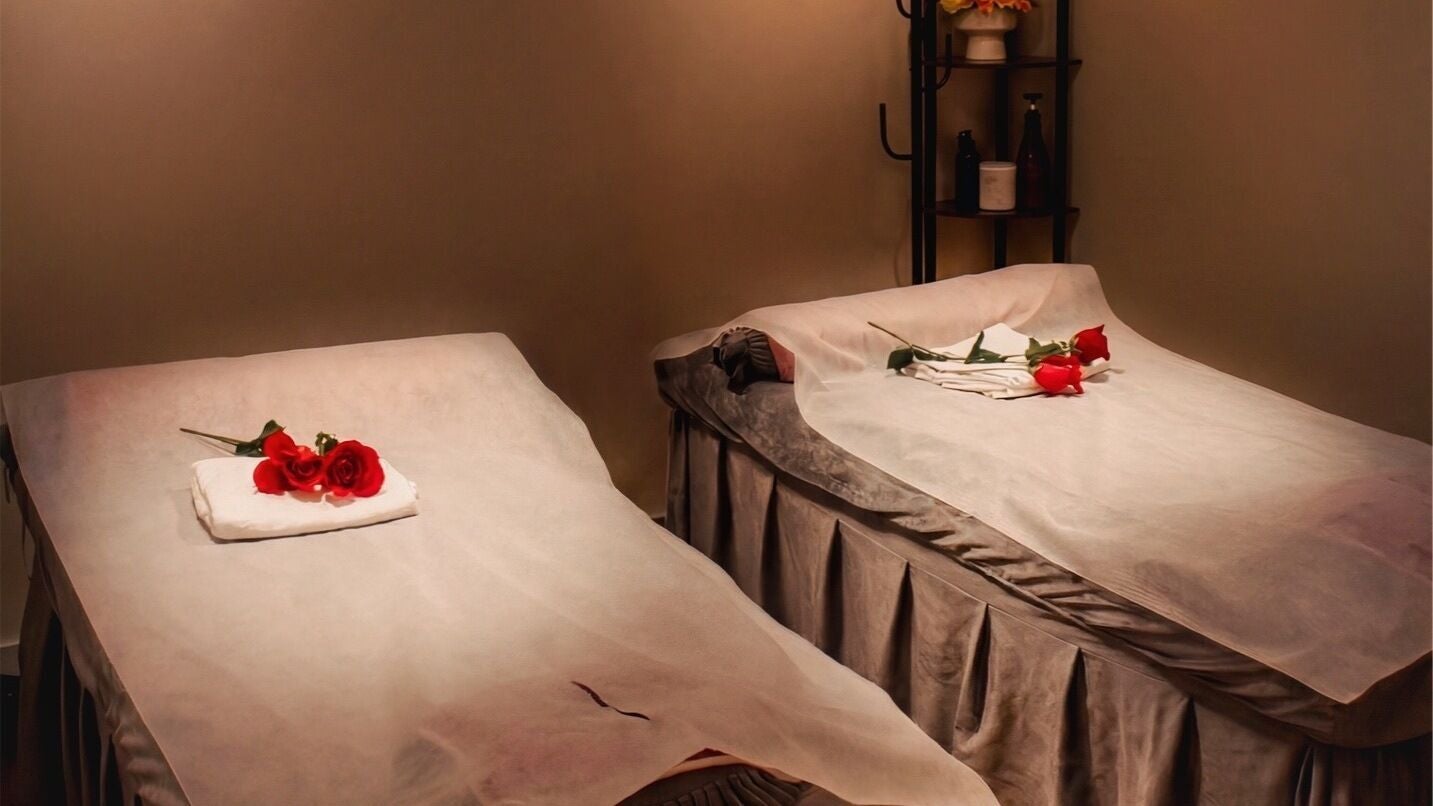 Two massage tables with red roses at WL Wellness Head Spa, Merrick, New York, US, creating a serene ambiance.