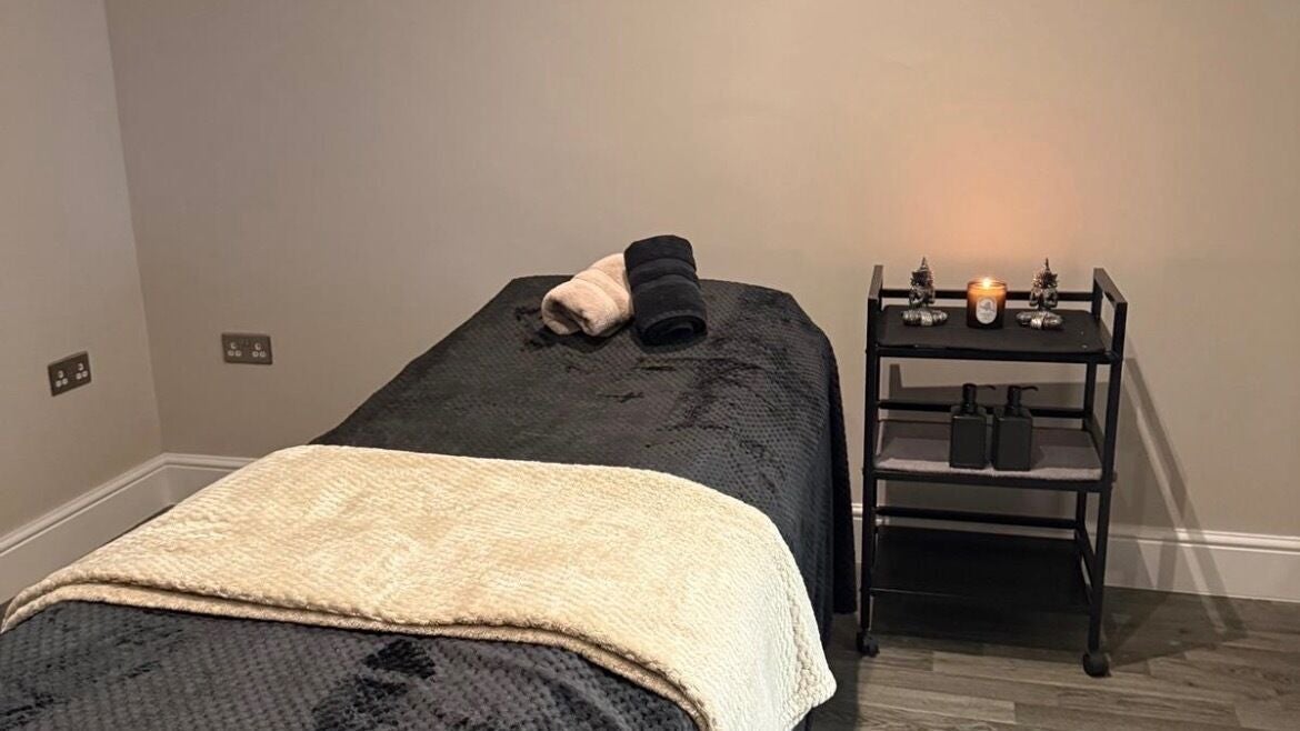 Calming massage room at Le Reve, Gravesend, England, GB with candles and neatly rolled towels.