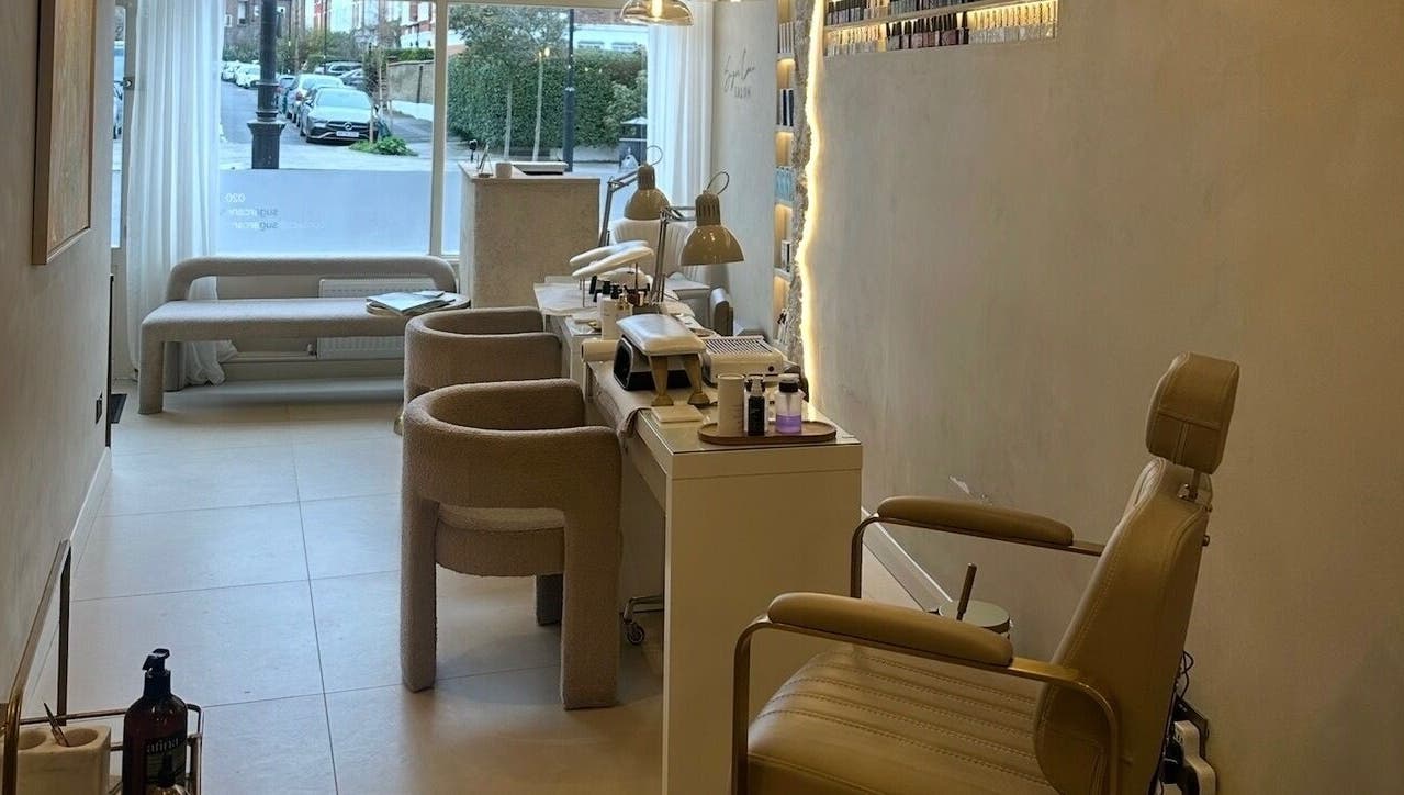 Interior view of Sugar Cane Salon in London, England, GB showcasing cozy seating and modern salon equipment.