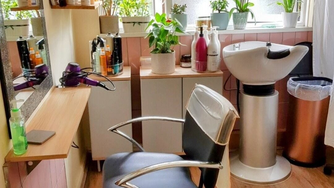 Elegant salon setup at Hair by Elena P in London, England, GB with styling chair and hair products.