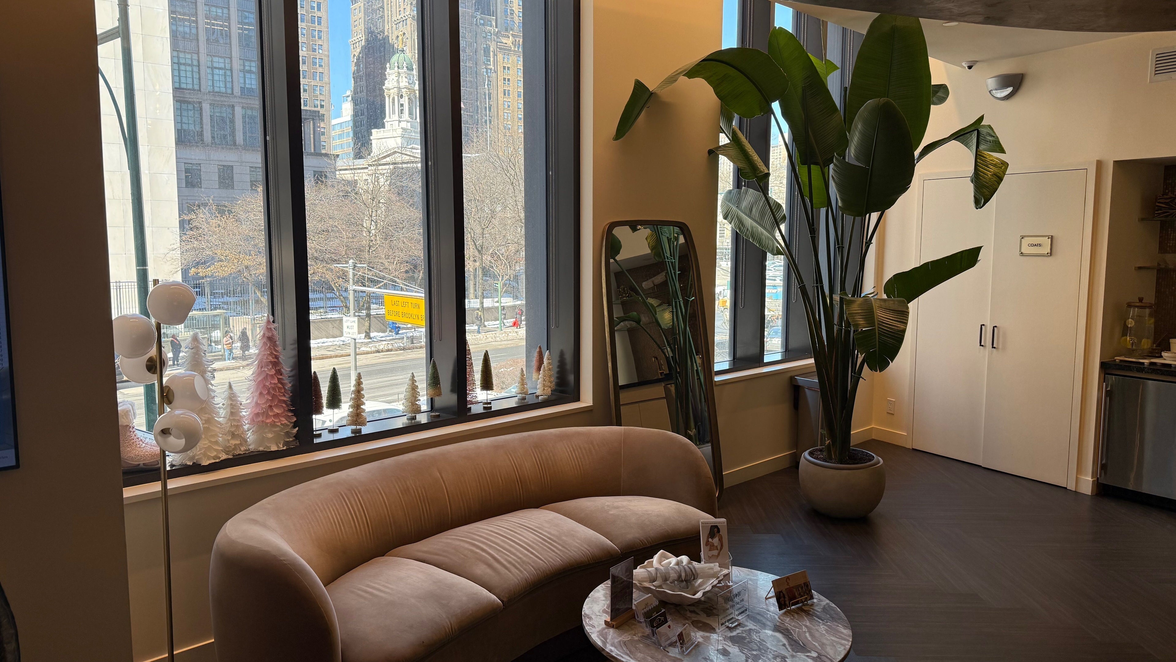 Cozy seating at Oshun’s Crown in Brooklyn, New York, US, with elegant decor and large windows.
