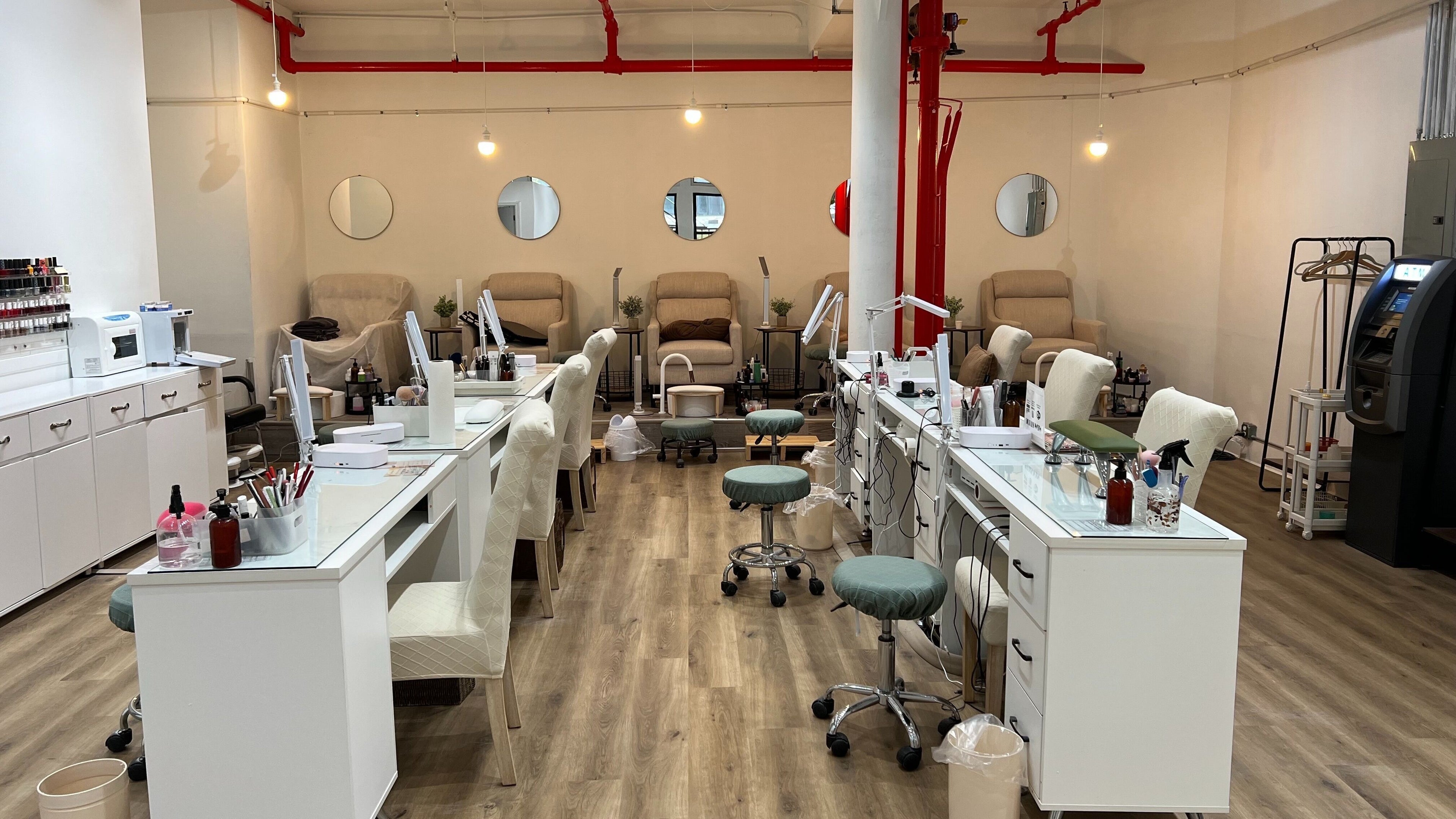 Chic interior of M&M Studio NYC nail studio, New York, New York, US with modern nail stations and cozy seating.