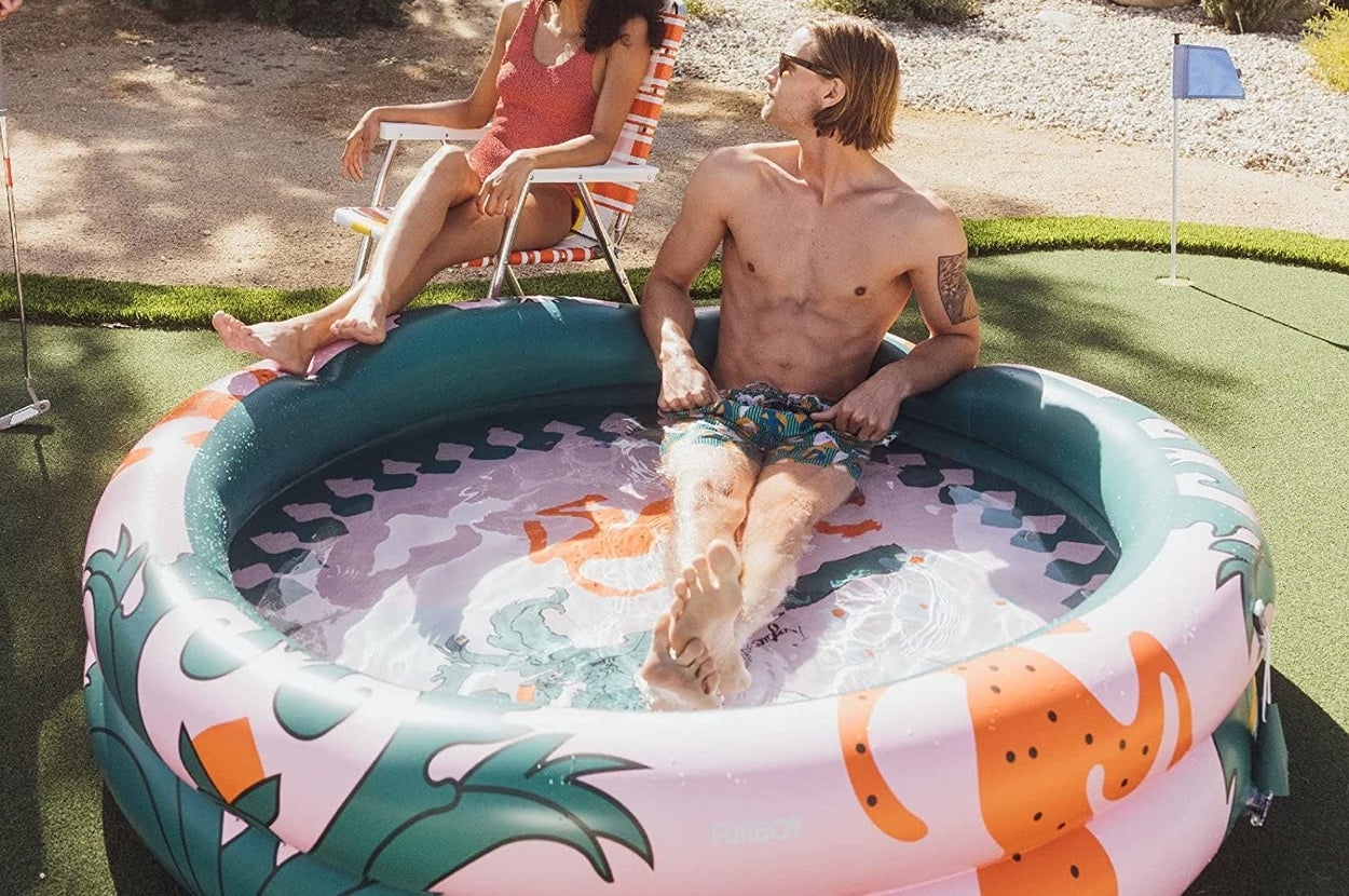 Two people enjoy a dip in a colorful pool
