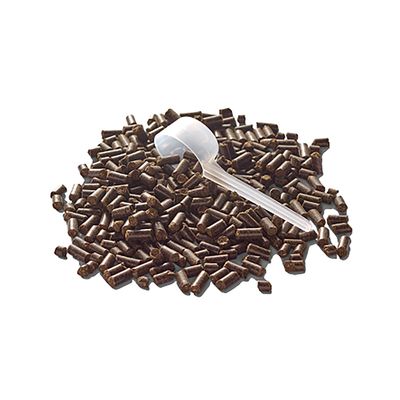 Halom sötét pellet átlátszó mérőkanállal, adagolásra alkalmas.