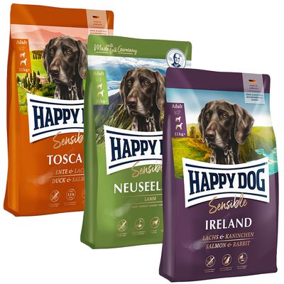 Tri pakiranja Happy Dog hrane za pse: Irland (lachs & kaninchen), Toscana (ente & lachs), Neuseeland (lamm & reis). Vidljiv tekst: Made in Germany, Supreme Sensible, Natural Life Concept.