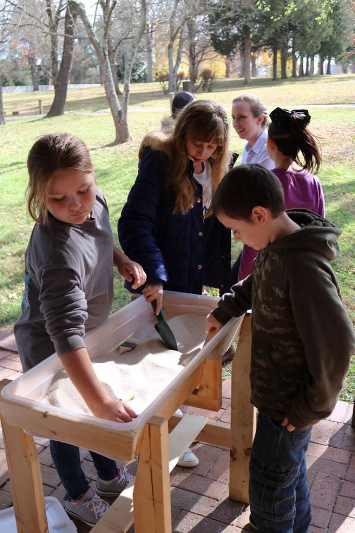 children playing with a sand table