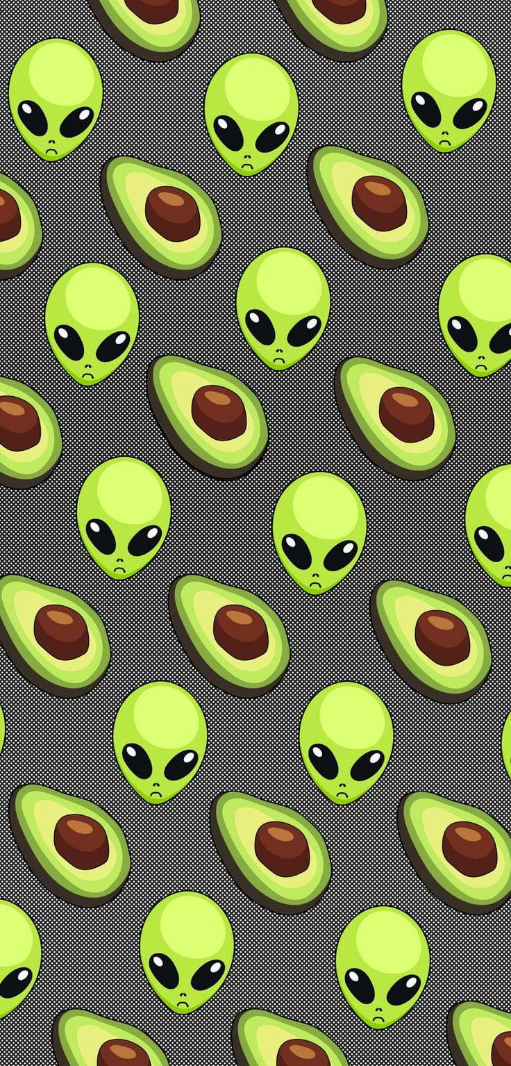 Repeating cartoon aliens and avocado slices on a gray background. — Fruit Wallpaper