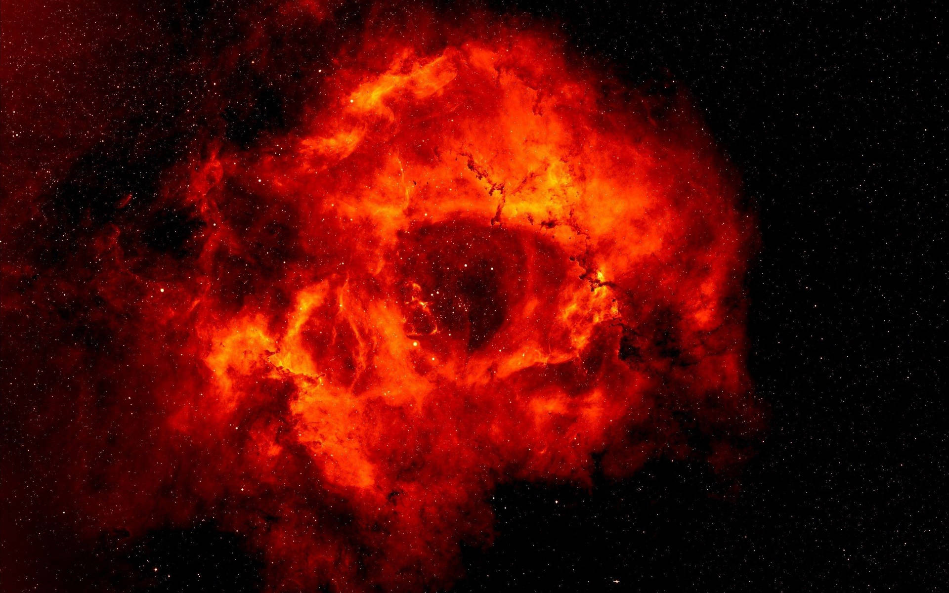 Vibrant red nebula glowing in deep space surrounded by stars.
