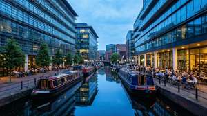 Peaceful canal scene in Birmingham's Brindleyplace at blue hour.