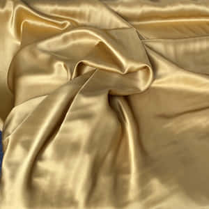 Umtecido lindo com uma aparência quente em tons de ouro e amarelo.