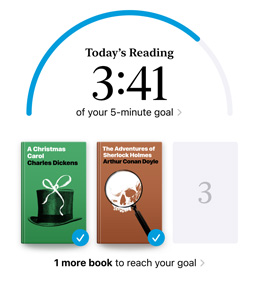 iPhone screen showing the Reading Goals interface in the Books app. At the top, there is a progress ring for a reading goal. Below the progress ring are three book covers. Beneath the book covers is text that one more book is needed to reach the 2024 goal of reading eight books.