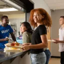 Young lady receiving food in a Covenant House Cafeteria