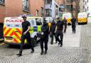 Officers from Police Scotland outside the headquarters of the Scottish National Party