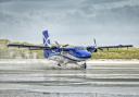 A Twin Otter aircraft, operated by Loganair, departing Barra airport on Traigh Mhor beach