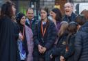 Minister for Business Richard Lochhead (right) joins pupils and staff from Holy Rood High School as they are entertained by Mercat Tours Storyteller Nicola Hamilton during A Day in Edinburgh.