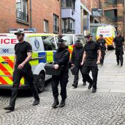 Officers from Police Scotland outside the headquarters of the Scottish National Party