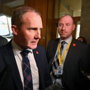 Former Health Secretary Michael Matheson, pictured in November 2023, facing media questions in the lobby of the Scottish Parliament over mobile roaming charges he incurred when abroad on holiday.