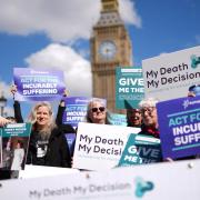 Campaigners in support of voluntary euthanasia protest outside Parliament in Westminster.