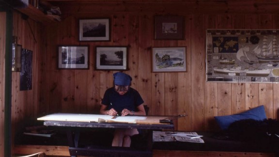 Wenche Selmer at the drawing board in her cabin on Beltesholmen.