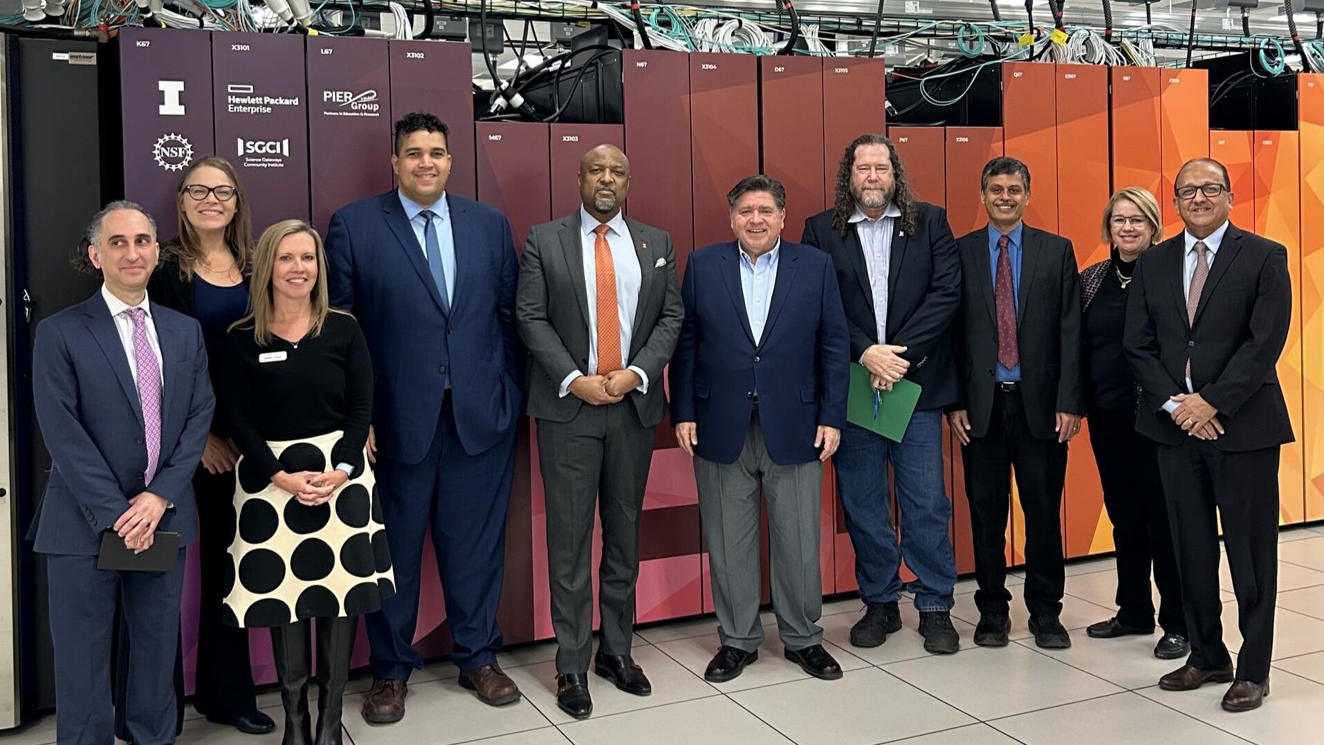NCSA and University of Illinois leadership with Illinois Gov. JB Pritzker in front of the Delta supercomputer.