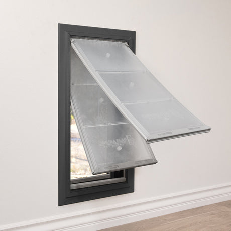 Endura Flap double-flap pet door for thick walls in bronze finish, three-quarter angle view from the right showing both clear flaps unlatched and pushed outward, the magnetic catch hardware visible inside the dark frame.