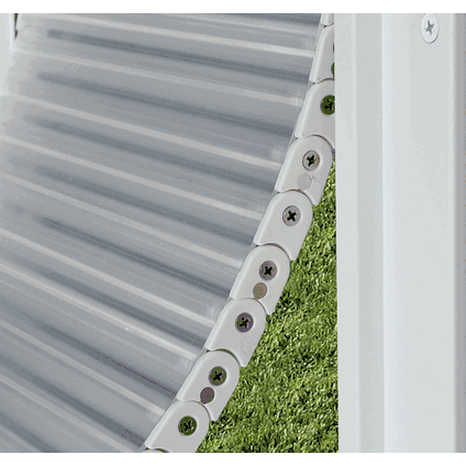 High Tech Armor Flex Pet Door for Walls, closeup of the edge of a clear vertically-ribbed flexible pet door flap with a continuous row of round flat white plastic discs along the edge, each with a dark center dot suggesting a magnetic seal that holds the flap closed against the frame.