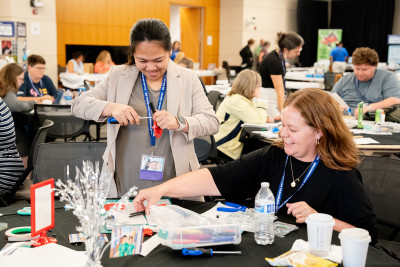 Two 2024 NSTI participants working on their invention challenge projects. 