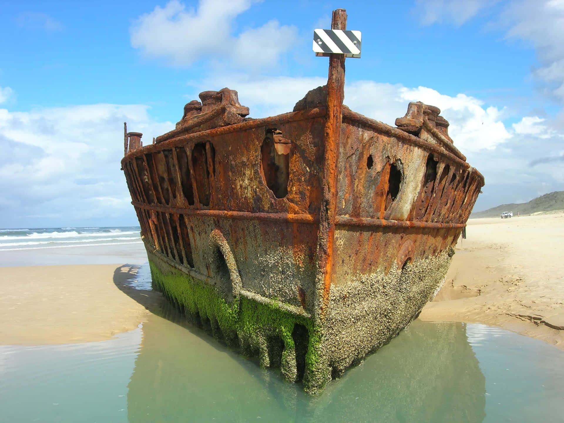 "the Ghostly Remnant: An Aerial View Of Shipwreck" Wallpaper