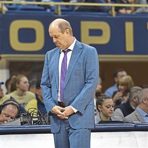 Kevin Stallings walks back to the Pitt bench as his team trailed by nearly 30 points Feb. 24 against Virginia at Petersen Events Center.