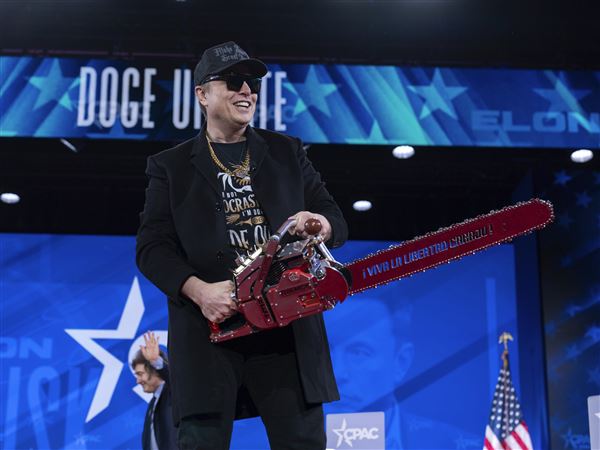 Elon Musk hold a chainsaw as he arrives to speak at the Conservative Political Action Conference, CPAC, at the Gaylord National Resort & Convention Center, Thursday, Feb. 20, 2025, in Oxon Hill, Md.