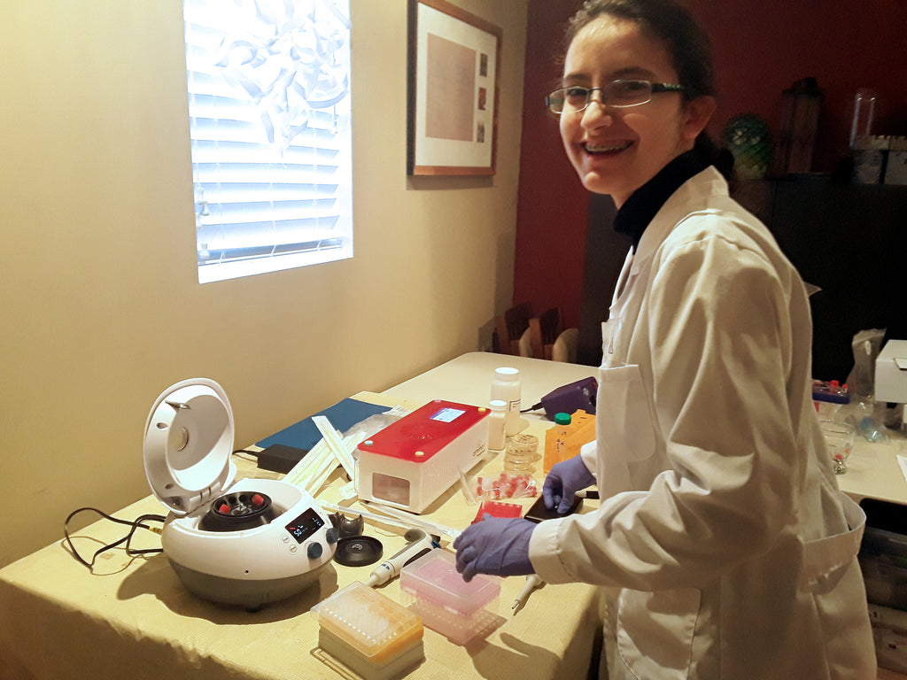 young scientist doing biology experiment for science fair