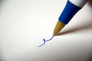 pen writting on paper