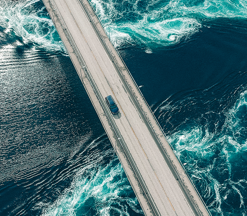 car driving over bridge