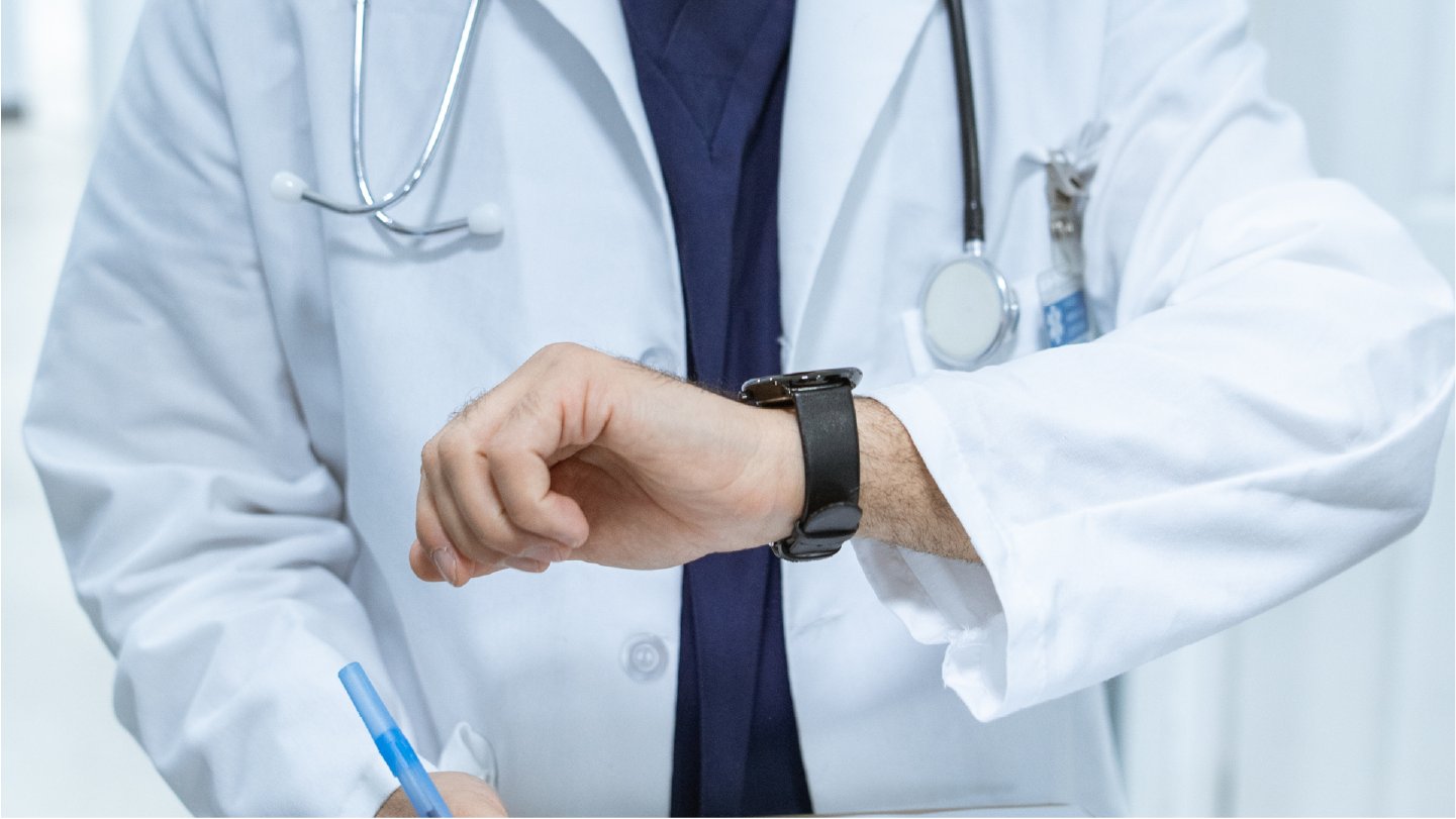 Doctor checking their watch thinking about how their billing system will start increasing patient payments