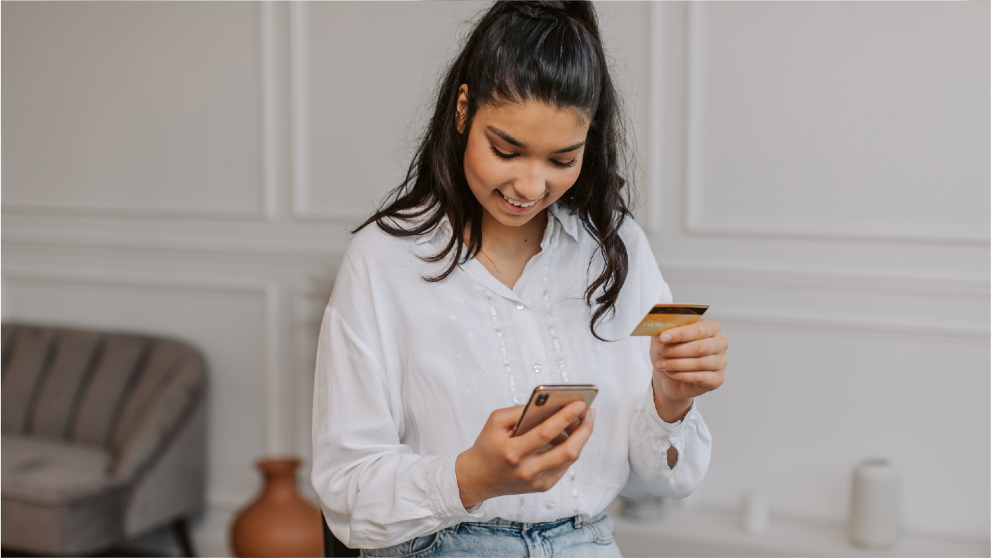 Woman looking at phone making seamless payments