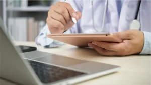 A doctor using their tablet to set up automated billing for their software.