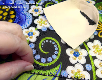 Wild Child Japanese Bead Embroidery Project: Filling in the background with black beads Embroidering the black beaded background with black beads and also showing the bead holder with the beads. (Wild Child Japanese Bead Embroidery by Mary Alice Sinton)
