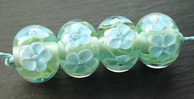 Lampwork glass encased floral beads by Laura Sparling Lampwork glass encased floral beads by Laura Sparling