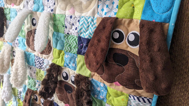 close up of dogs on dog quilt for baby close up of dogs on dog quilt for baby